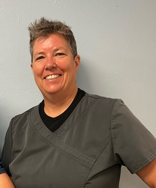 Photo of Dianna Ullery, the office manager at Gainesville Medical Injury Center: Momentum Rehab & Chiropractic, posing with a smile.