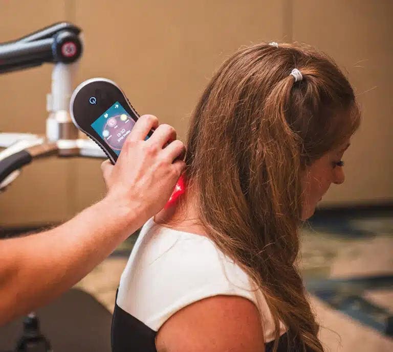 Augustine-Chiropractic-Female-Getting-Laser-Therapy-on-Neck Female patient receiving laser therapy on her neck at Augustine Chiropractic in Wesley Chapel, Florida.
