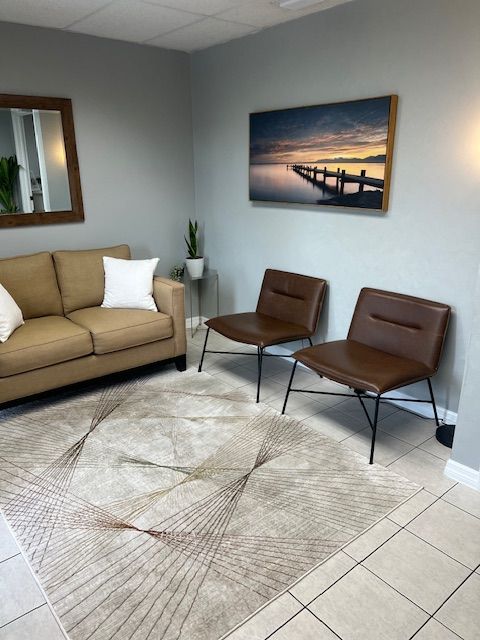 Waiting Area 2 View of waiting area with Sofa on far wall and two chairs on right wall at St. Petersburg Medical Injury Center: Rainey Chiropractic