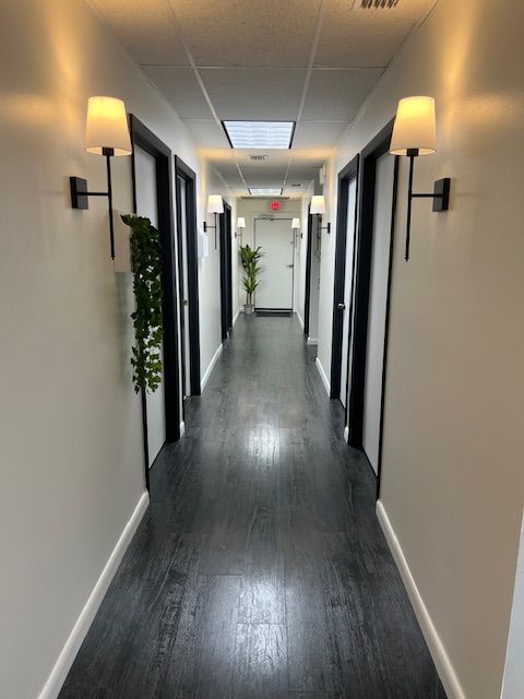Hallway at Rainey Chiropractic View down long hallway with doors on both sides at St. Petersburg Medical Injury Center: Rainey Chiropractic